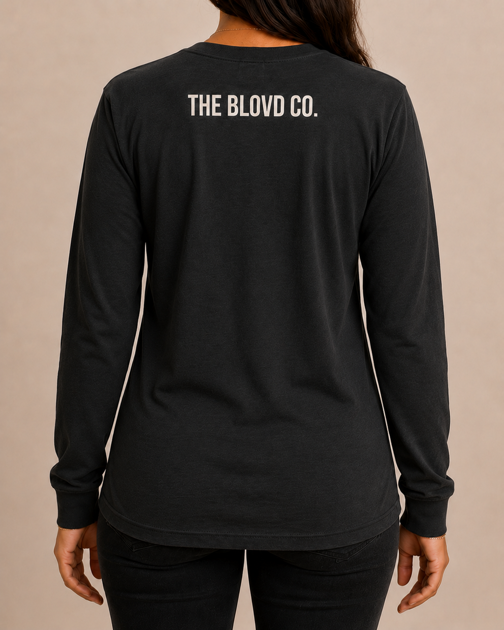 THE BLOVD Lion Classic Bella+Canvas 3501 Vintage Black long sleeve with Soft Linen upper-back mark, approved female rear studio view
