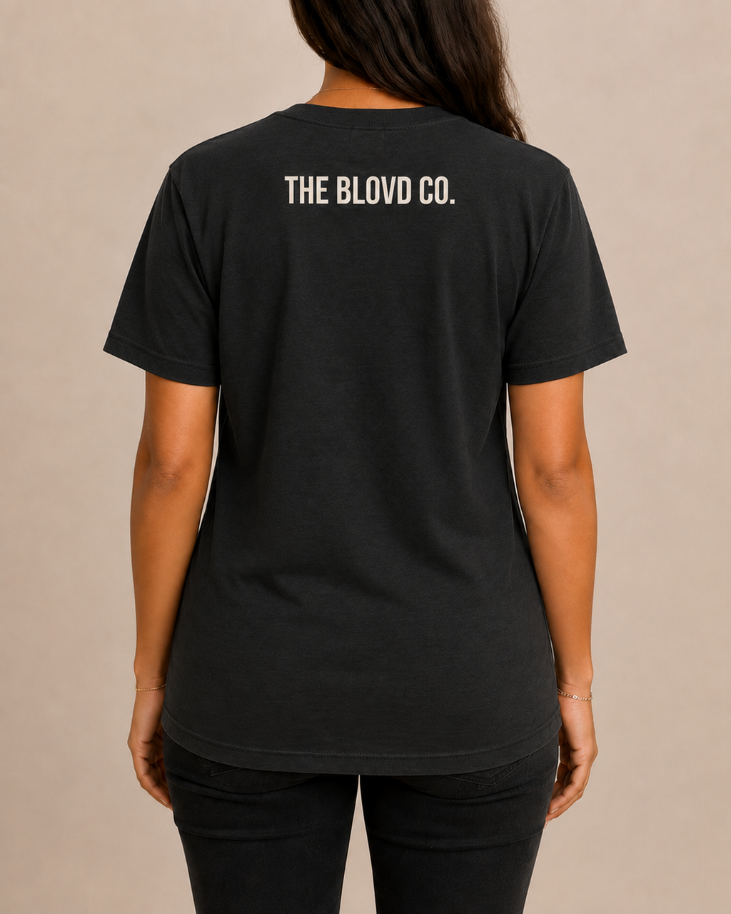 THE BLOVD Lion Classic on Bella+Canvas 3001 Vintage Black with Soft Linen upper-back mark, female rear view