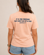 Freedom | Galatians 5:1 Heather Peach Bella+Canvas tee with Heritage Navy Scripture artwork, modeled back view