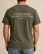 Freedom | Galatians 5:1 Moss Comfort Colors tee with Coyote Tan Scripture artwork, modeled back view