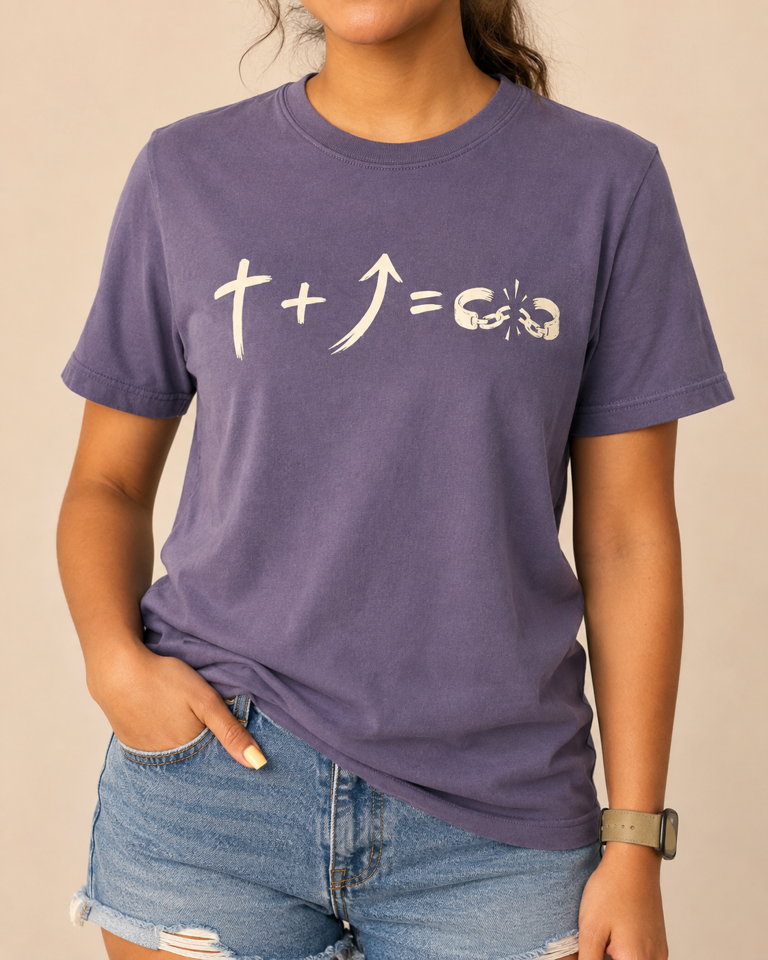 Freedom Galatians 5:1 Comfort Colors Violet tee with BLOVD Antique Bone artwork, approved female warm-neutral studio front view cropped below the lips with denim shorts visible.