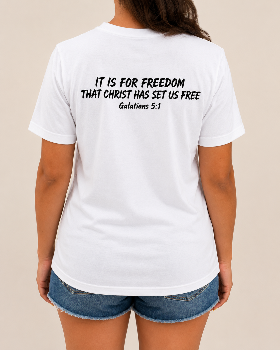 Freedom Galatians 5:1 Bella+Canvas White tee with BLOVD True Black Scripture artwork, approved female warm-neutral studio back view showing the back of the neck.