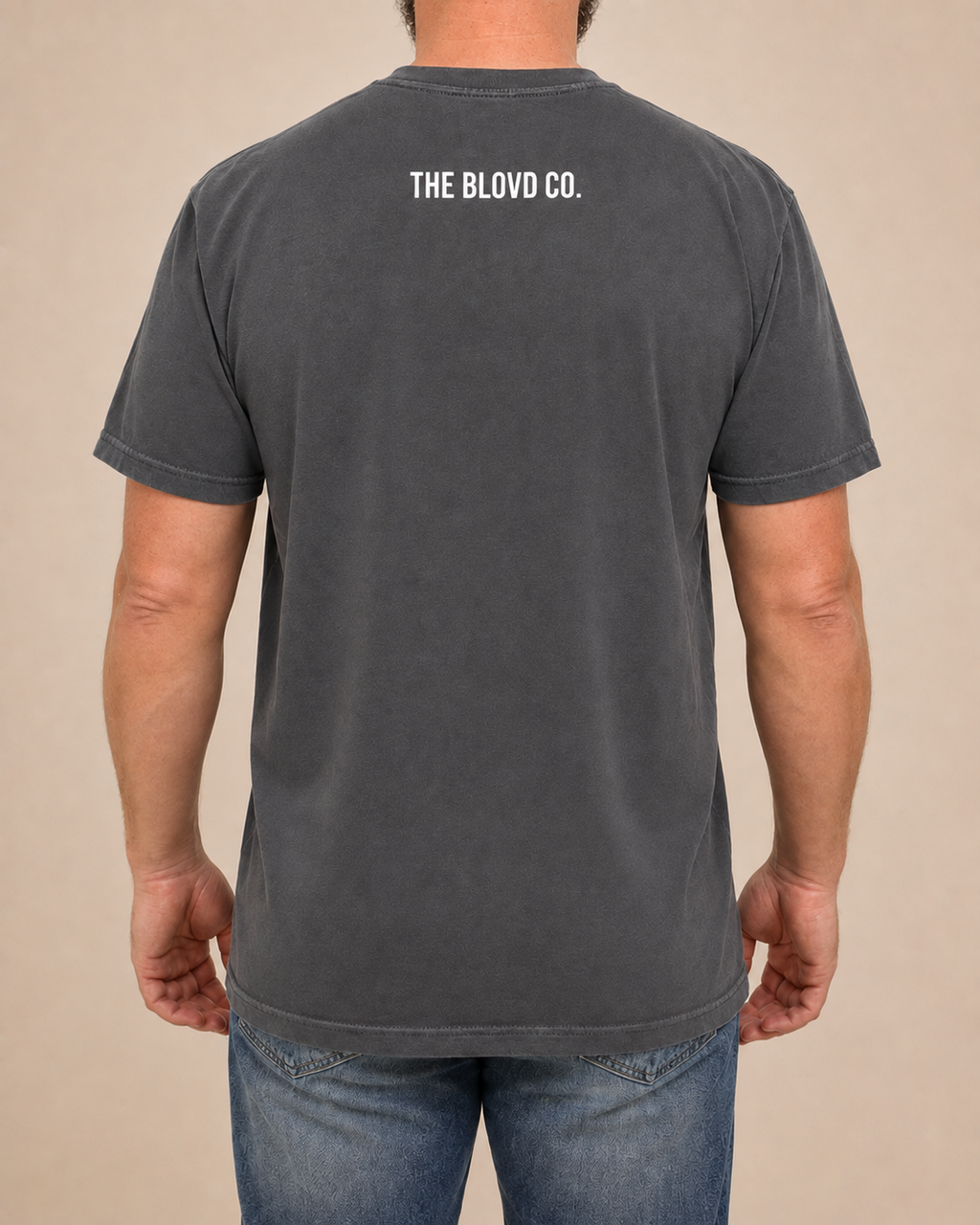 THE BLOVD Lion Classic Pepper Comfort Colors T-shirt with white THE BLOVD CO. upper-back mark, approved warm-neutral studio back view