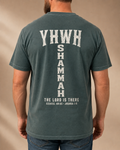 YHWH SHAMMAH Blue Spruce T-shirt with large vertical back design, warm-neutral studio back view